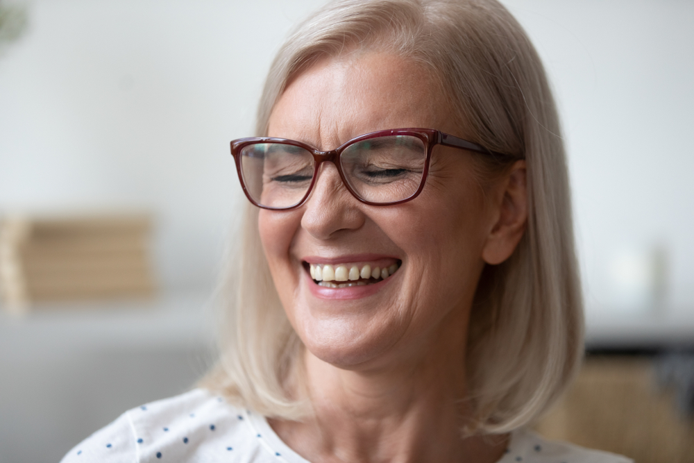 Older woman smiling confidently, showcasing results of durable dental crown restoration – Dental Crowns Highland Park