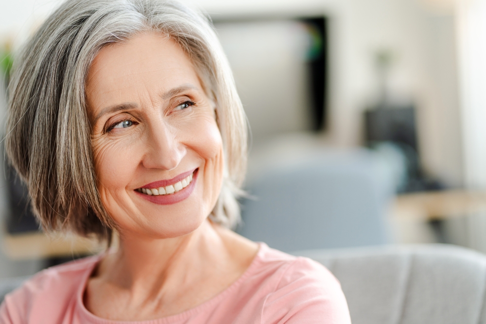 Happy older woman smiling naturally, representing successful tooth restoration with dental implants – Dental Implants Roseville