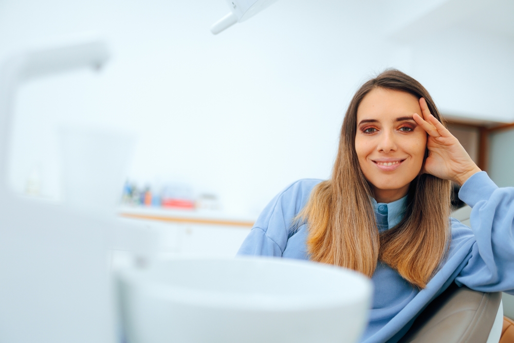 Woman smiling comfortably in dental chair during visit for gentle dental care – Dentist Prospect Park