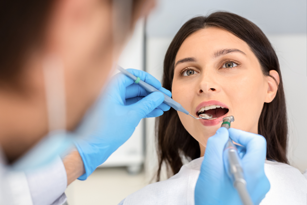 Portrait of female patient having treatment at dentist, close up